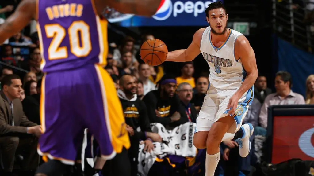 Denver Nuggets forward Danilo Gallinari controls the ball against Dwight Buycks against the Los Angeles Lakers