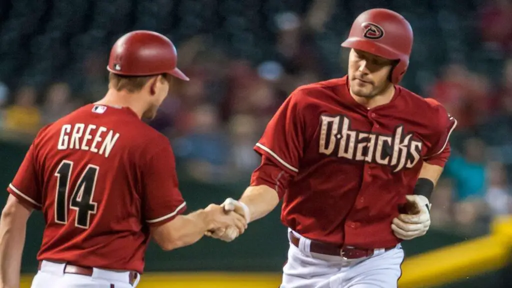 Arizona Diamondbacks player A.J. Pollock shakes hands with third base coach Andy Green after a first-inning home run during an MLB game against the Houston Astros