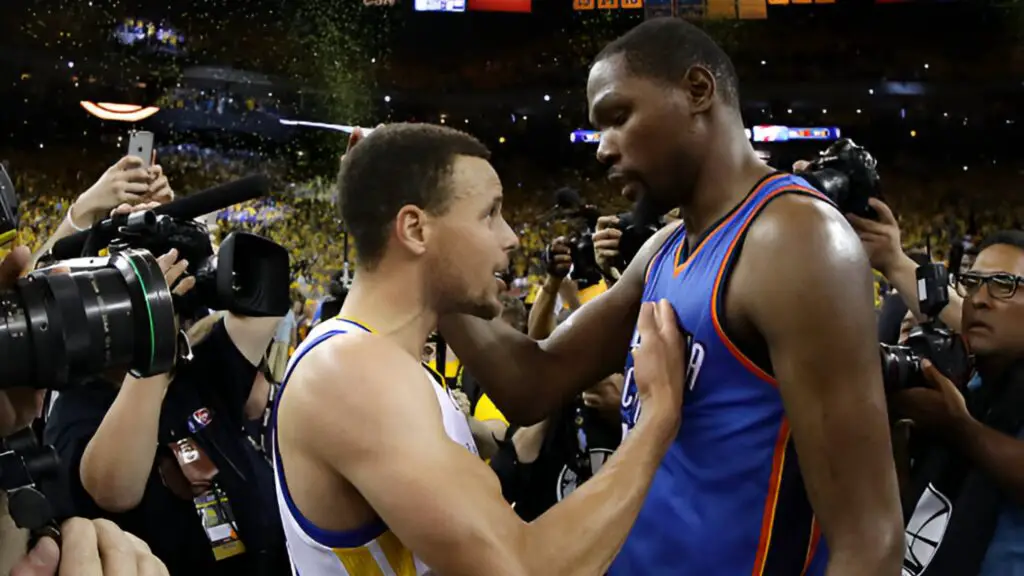 Former Oklahoma City Thunder star Kevin Durant speaks with Golden State Warriors star Stephen Curry after their 96-88 win in Game Seven of the Western Conference Finals during the 2016 NBA Playoffs