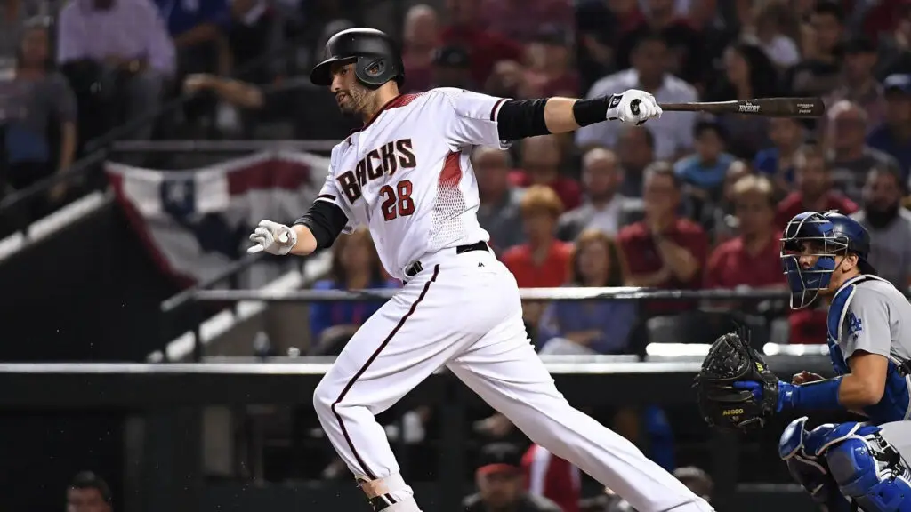 Arizona Diamondbacks player JD Martinez follows through on a swing during Game Three of the National League Divisional Series against the Los Angeles Dodgers