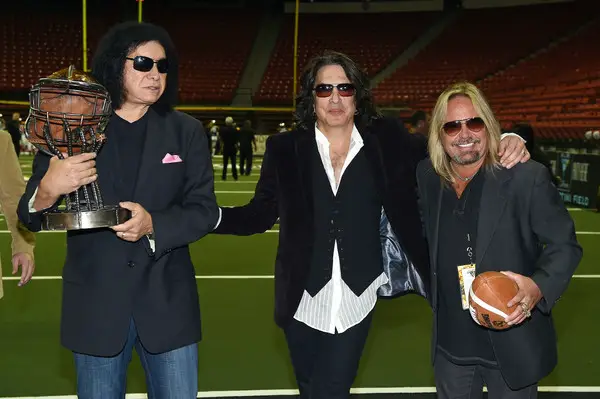Gene Simmons stands with Paul Stanley and Vince Neil on an Arena Football League field (Getty Images)