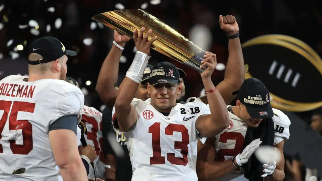 Alabama Crimson Tide quarterback Tua Tagovailoa holds the College Football Playoff Championship Trophy while celebrating with his team after defeating the Georgia Bulldogs in overtime to win the CFP National Championship presented by AT&T