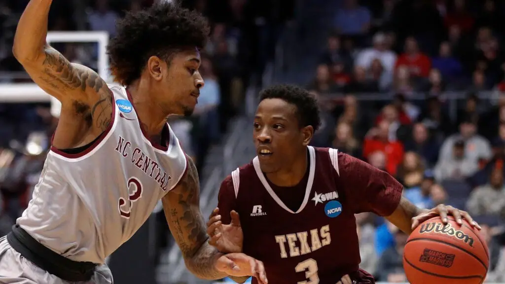 Texas Southern Tigers basketball player Demontrae Jefferson dribbles as Brandon Goldsmith defends against the North Carolina Central Eagles in the first half during the First Four of the 2018 NCAA Men's Basketball Tournament