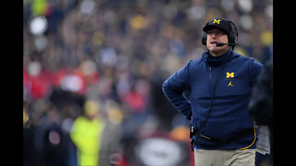 Michigan Wolverines head coach Jim Harbaugh looks up at the scoreboard in the third quarter after the Ohio State Buckeyes scored