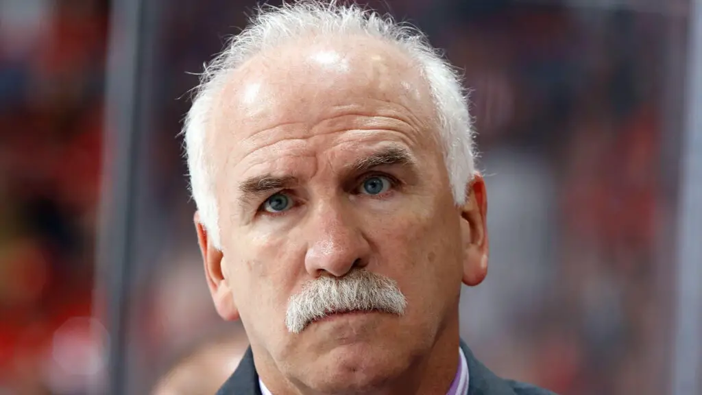 Former Chicago Blackhawks head coach Joel Quenneville looks on as his team faces the Calgary Flames
