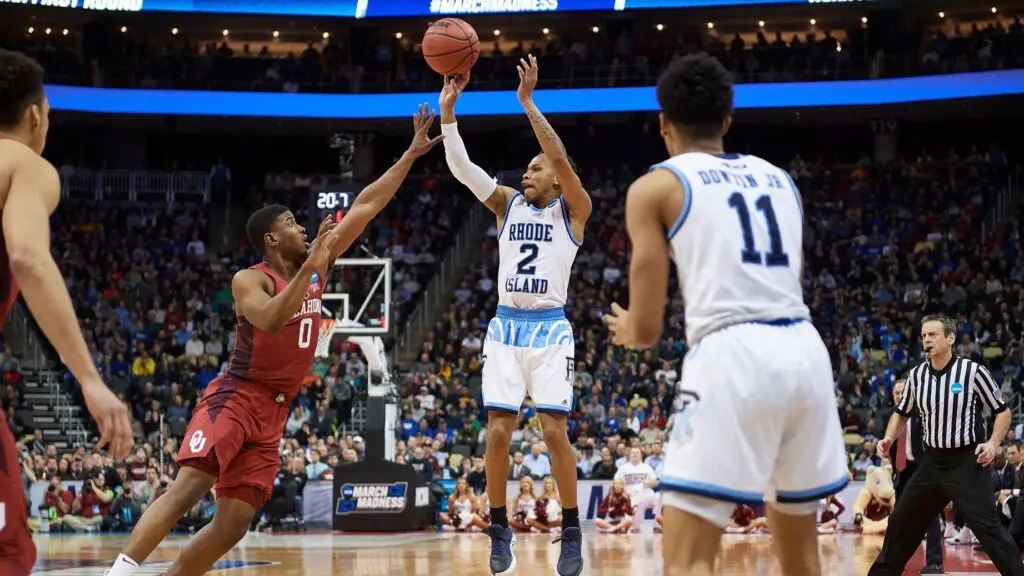 Rhode Island Rams guard Fatts Russell shots a three point basket during the second half of the first round of the NCAA Division I Men's Championships between the Rhode Island Rams and the Oklahoma Sooners