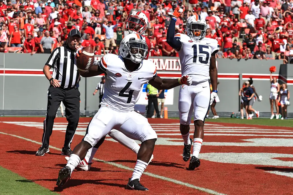 Virginia Cavaliers running back Olamide Zaccheaus celebrates a touchdown against the North Carolina State Wolf Pack