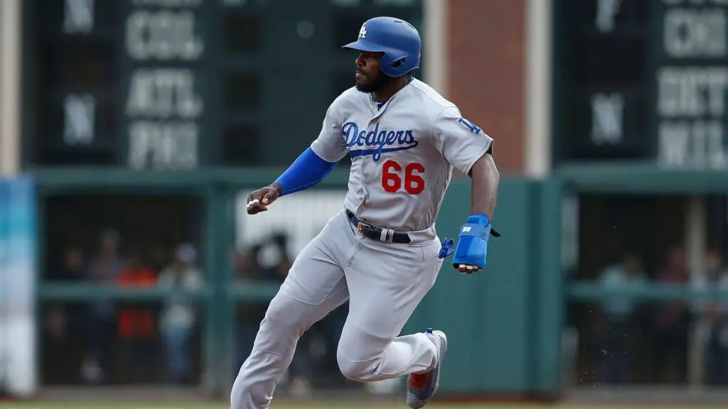 Los Angeles Dodgers outfielder Yasiel Puig rounds second base on his way to third base on a double hit by teammate Yasmani Grandal in the top of the seventh inning against the San Francisco Giants
