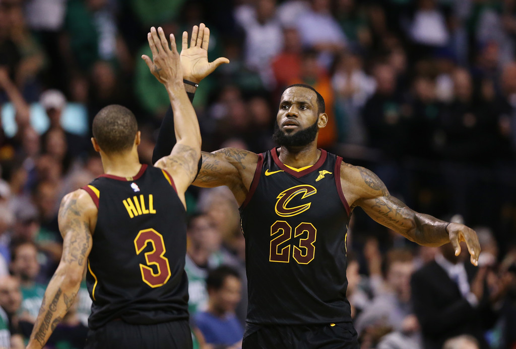 Cleveland Cavaliers star LeBron James celebrates with George Hill in the second half in Game 7 against the Boston Celtics of the Eastern Conference Finals