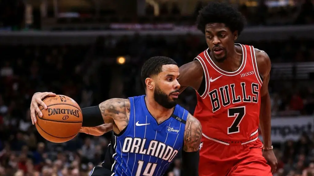 Chicago Bulls player Justin Holiday defends against D.J. Augustin against the Orlando Magic as he drives to the basket in the first quarter