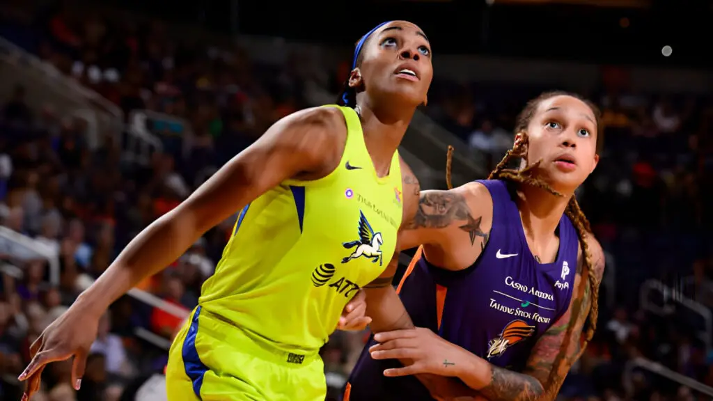 Phoenix Suns star Brittney Griner and Dallas Wings player Glory Johnson fight for position