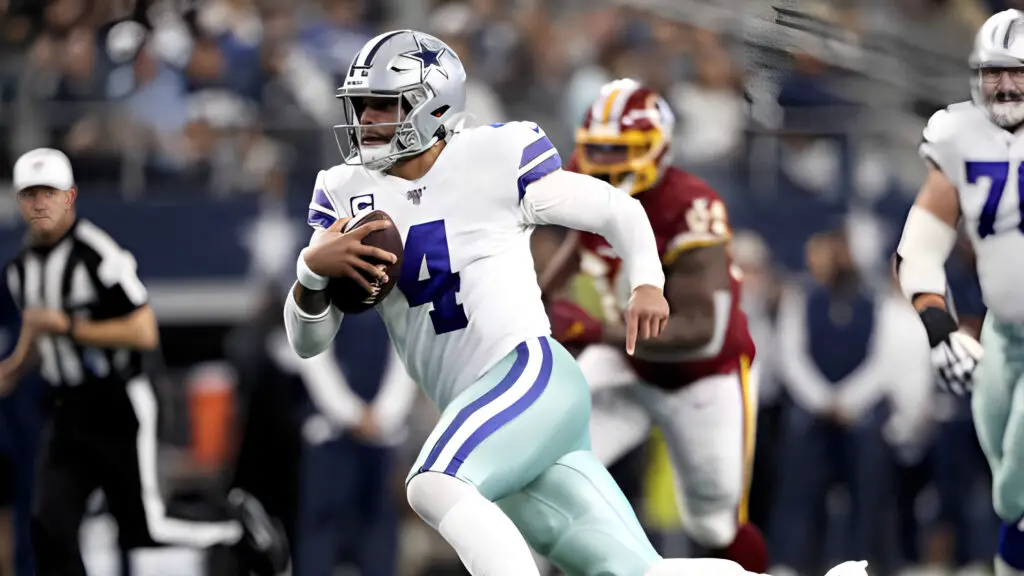 Dallas Cowboys quarterback Dak Prescott runs with the ball in the first quarter against the Washington Redskins in the game 