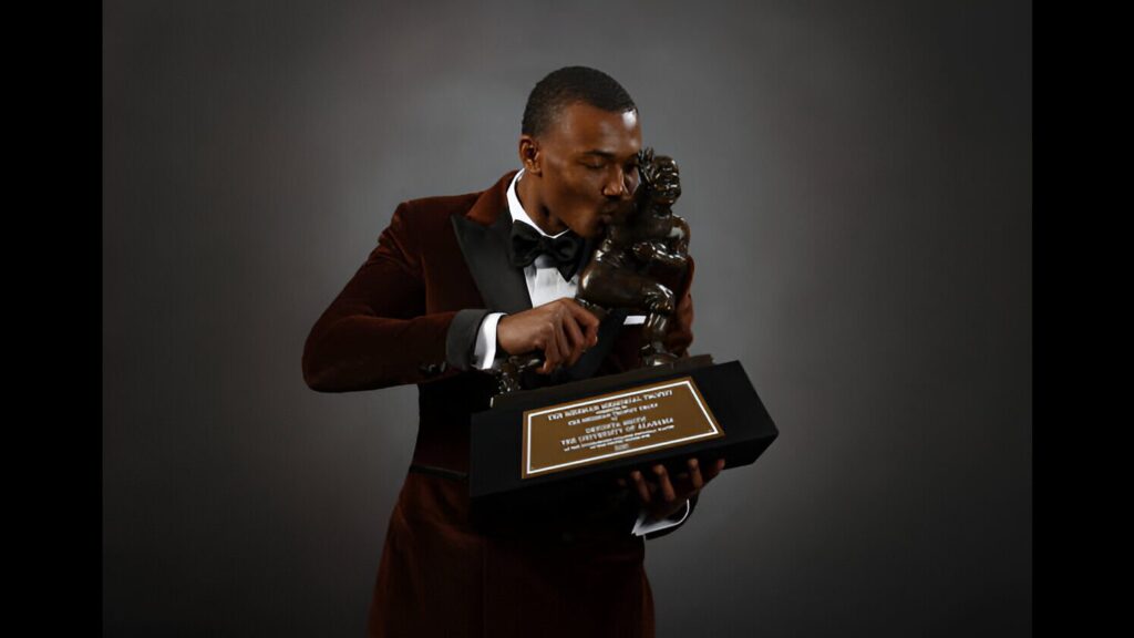 Alabama Crimson Tide wide receiver DeVonta Smith poses with the Heisman Memorial Trophy