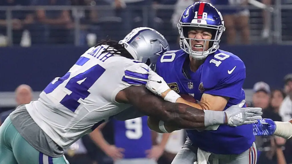Former Dallas Cowboys linebacker Jaylon Smith tackles New York Giants quarterback Eli Manning in the third quarter