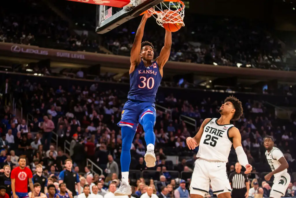 Kansas Jayhawks player Ochai Agbaji dunks the basketball against the Michigan State Spartans in the 2021 State Farm Champions Classic