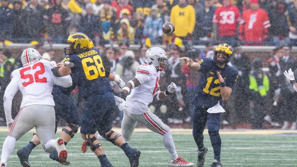 Michigan Wolverines quarterback Cade McNamara attempts to throw the football against the Ohio State Buckeyes