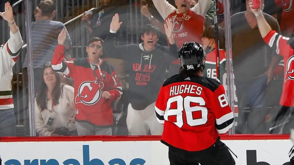 New Jersey Devils star Jack Hughes celebrates with the fans after scoring a goal 