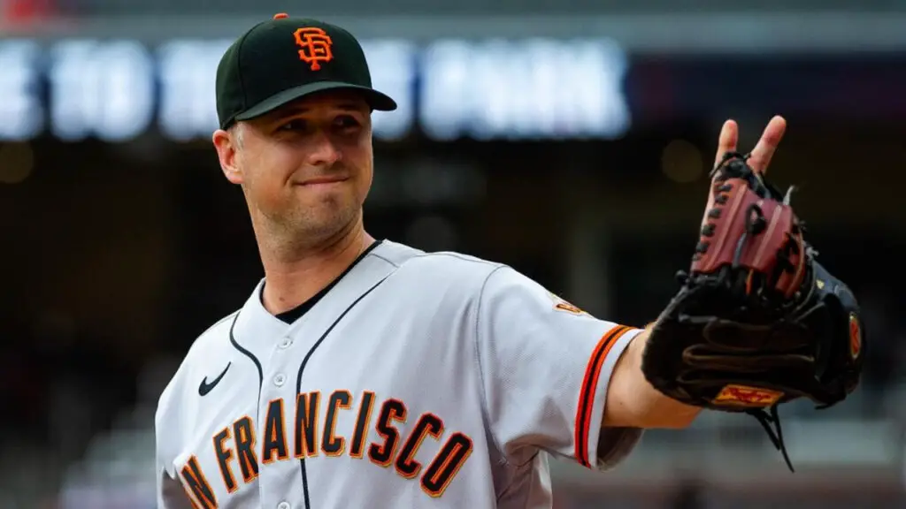 Former San Francisco Giants pitcher Kevin Gausman waves to someone with a glove in his hand