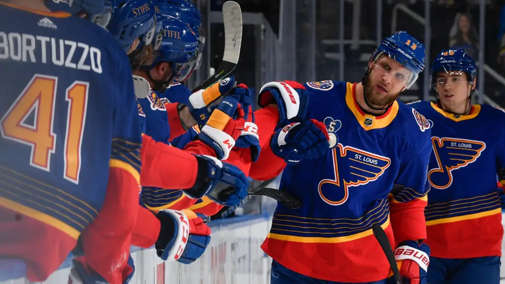 Former St. Louis Blues player Kyle Clifford pounds his teammates after a goal