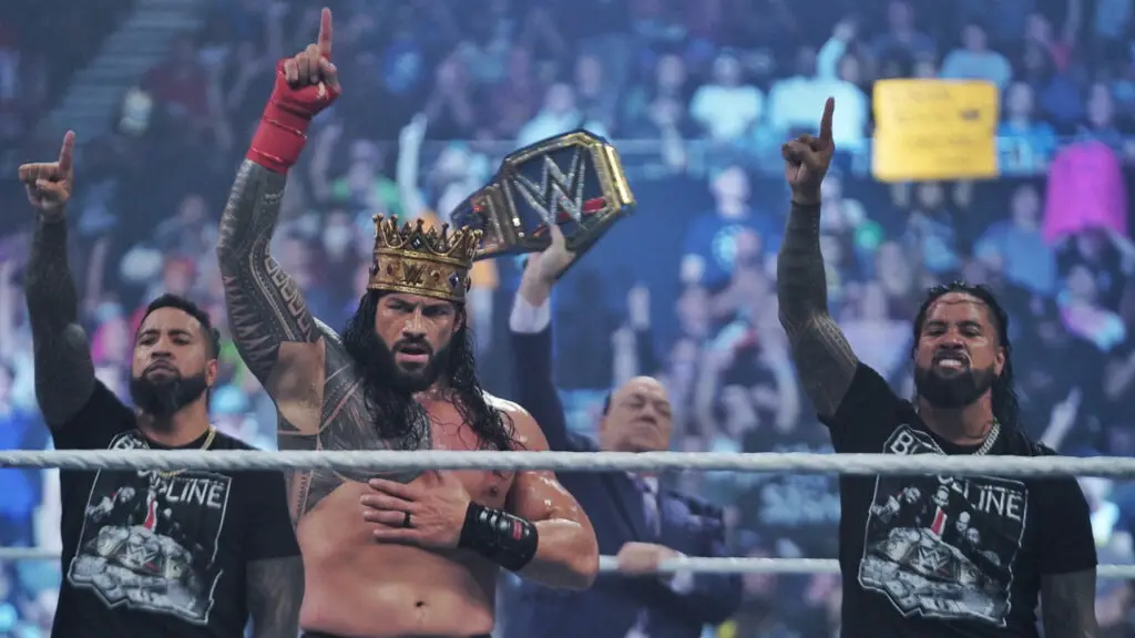 WWE Superstar Roman Reigns celebrates after a win with The Usos