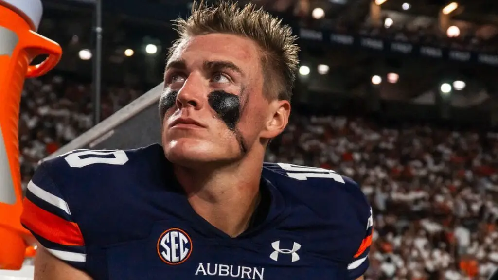 Former Auburn Tigers quarterback Bo Nix sits on the sidelines during a game