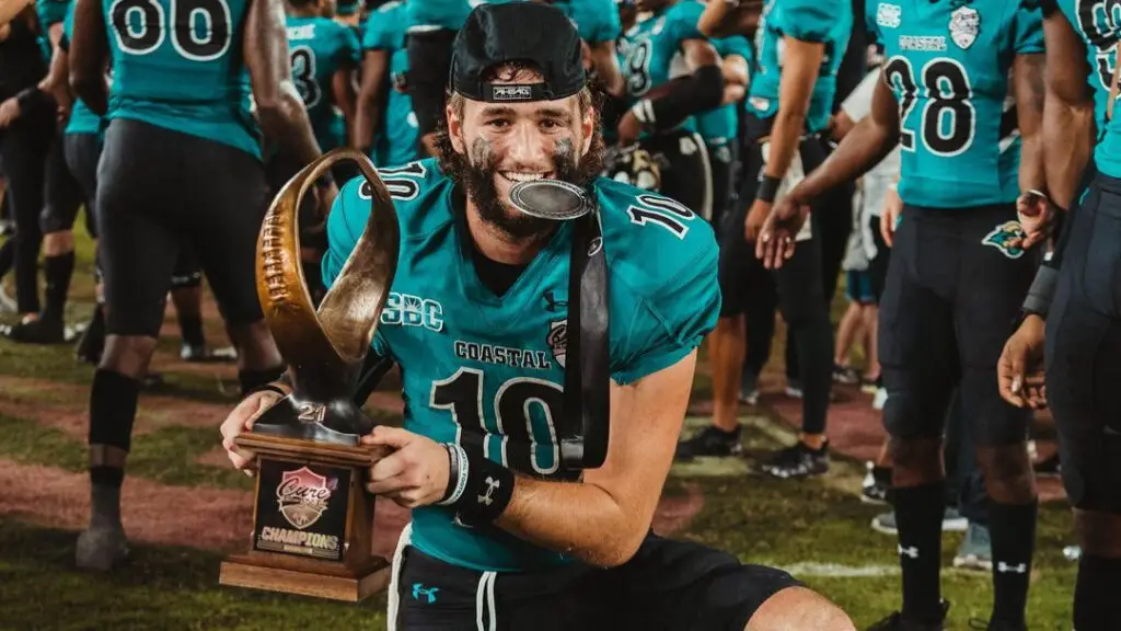 Coastal Carolina Chanticleers quarterback Grayson McCall celebrates with the Tailgreeter Cure Bowl trophy after a win over Northern Illinois Huskies