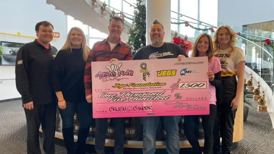 Street Outlaws No Prep Kings competitor Dean "Disco Dean" Karns makes a donation to the JEGS Foundation before Christmas