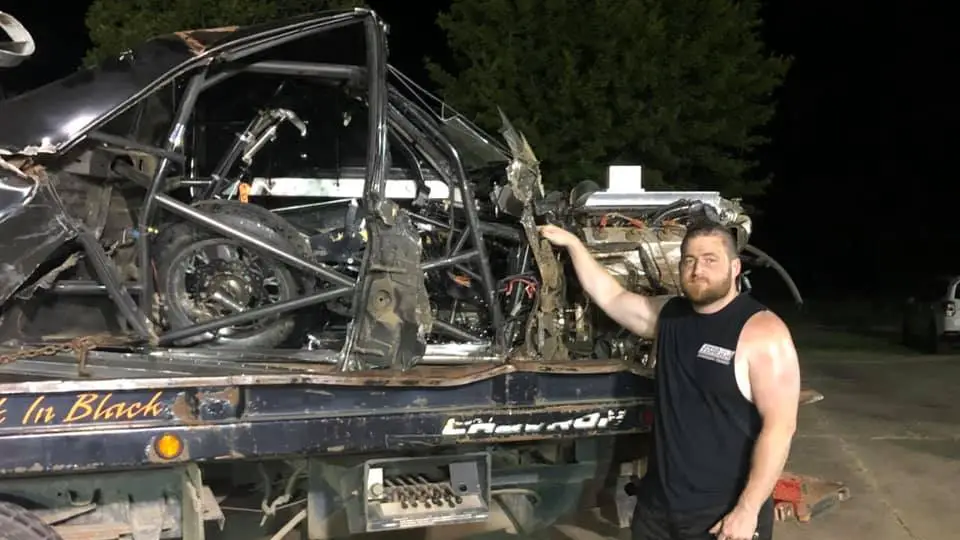 Street Outlaws competitor Chris "Kamikaze Chris" Day stands next to the Elco that he crashed during the taping of the 2020 Street Outlaws season