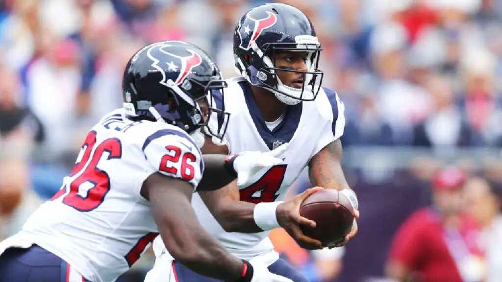Houston Texans quarterback Deshaun Watson hands off the ball to Lamar Miller against the New England Patriots