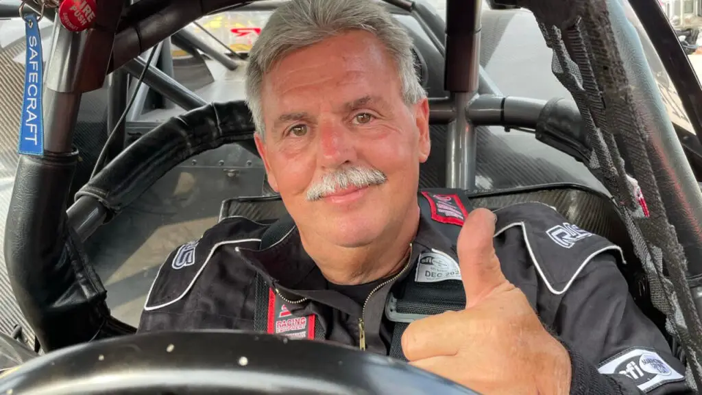 Street Outlaws competitor Wayne Smozanek gives a thumbs up from inside his race car