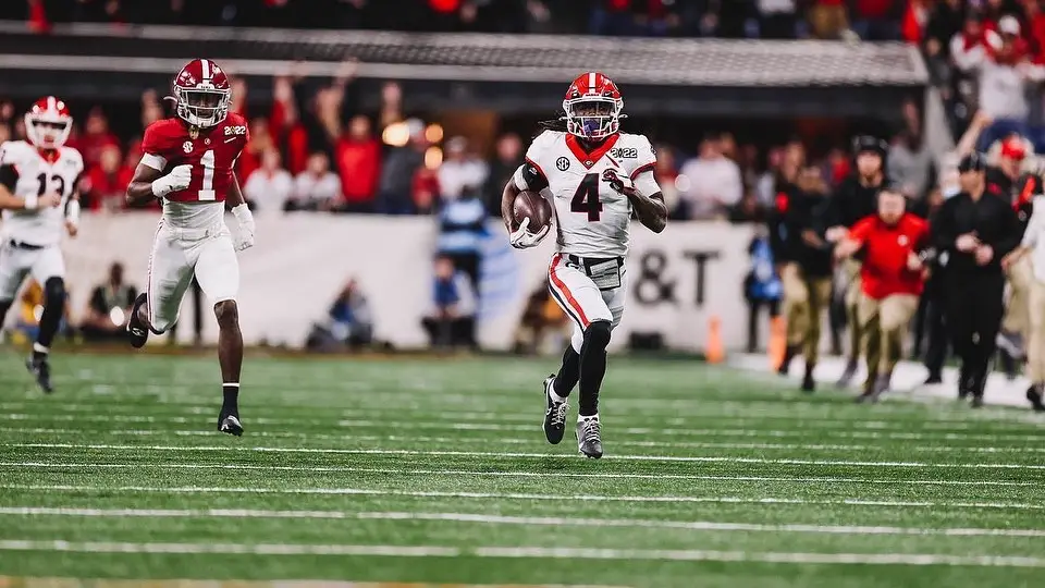 Georgia Bulldogs running back James Cook carries the football on a long run against the Alabama Crimson Tide in the 2022 College Football Playoff National Championship 