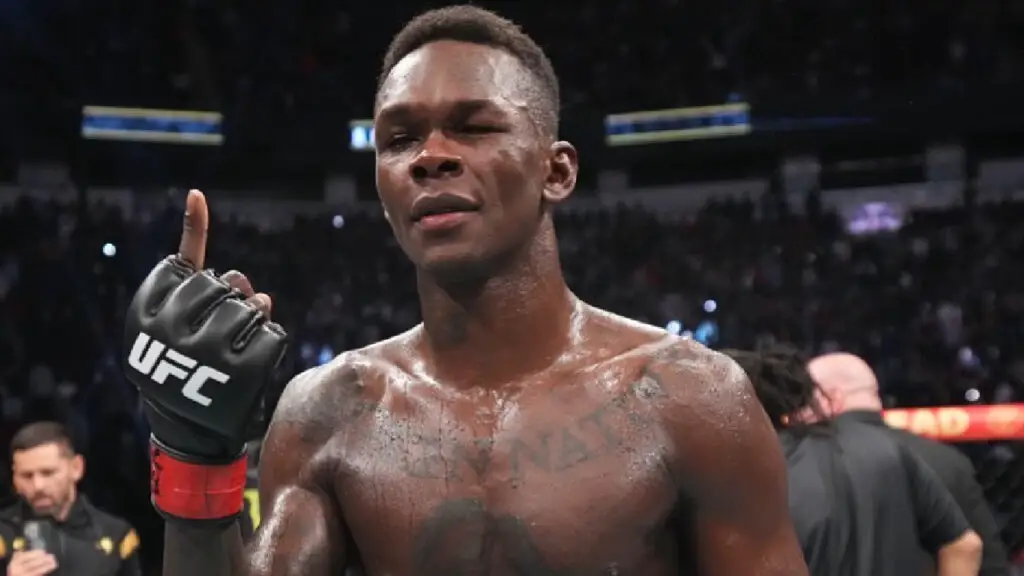 UFC Middleweight Champion Israel Adesanya celebrates by pointing up one finger after defeating Robert Whittaker by unanimous decision