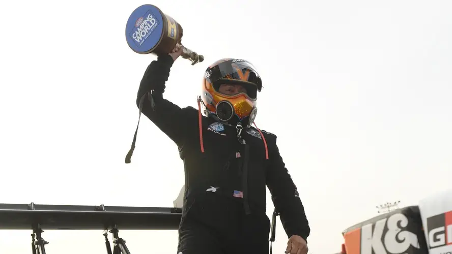 Scrappers Racing sponsored driver Mike Salinas celebrates after winning the Wally at the NHRA Arizona Nationals