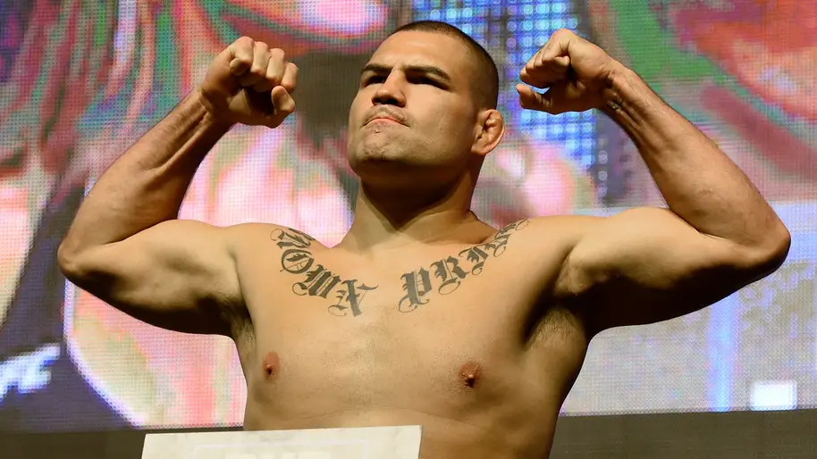 Former UFC star Cain Velasquez poses on the scale during his weigh-in for UFC 200