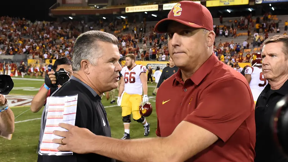 Former USC Trojans head coach Clay Helton shakes hands with former Arizona State Sun Devils head coach Todd Graham at the end of a 48-17 win