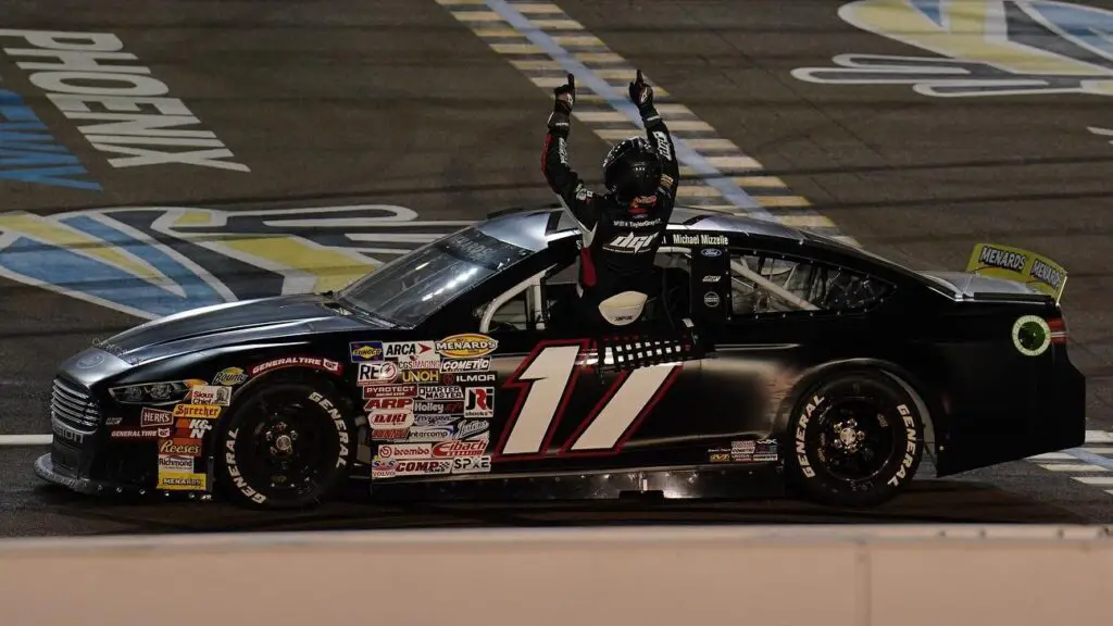 David Gilliland Racing driver Taylor Gray points to the sky after winning the General Tire 150