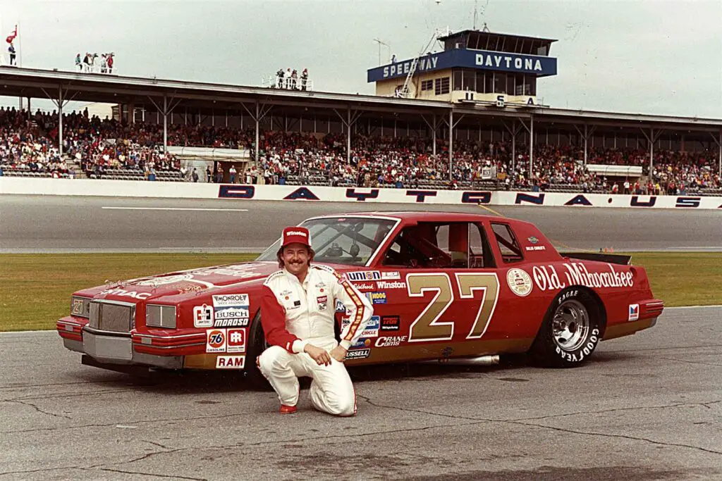 Former NASCAR driver Tim Richmond sits near his car before a race at Daytona Speedway