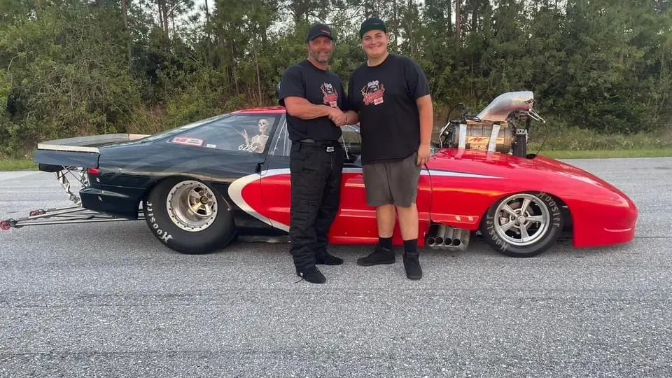 Street Outlaws No Prep Kings driver Stan Allen and Will Race shaking hands in front of the Tropical Thunder race car after their big announcement