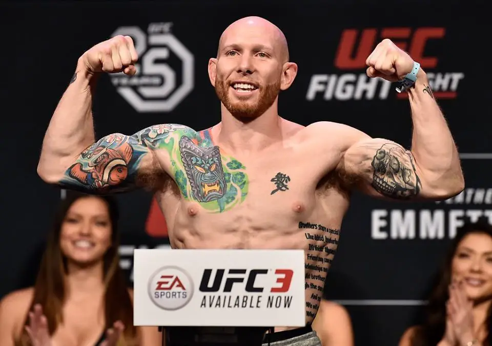 UFC fighter Josh Emmett is flexing after a weigh-in for one of his fights