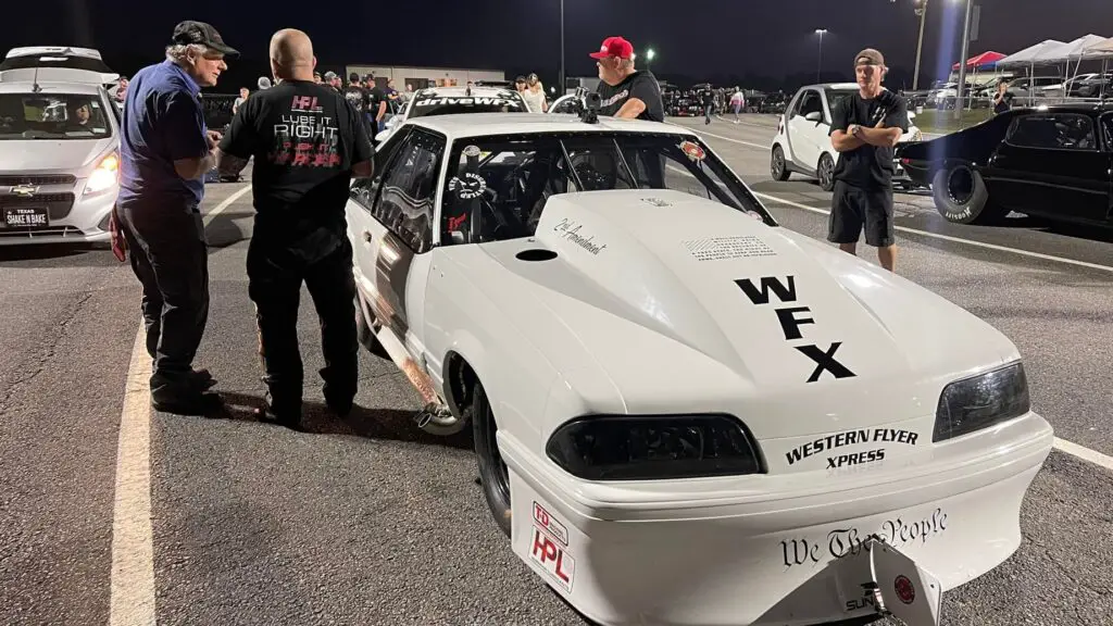 Street Outlaws 405 drag racer Chuck Seitsinger talking to a track official before making a pass at the Street Outlaws No Prep Kings show