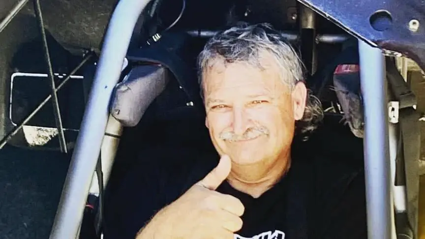 Funny Car driver Ken Singleton gives a thumbs up in his Funny Car