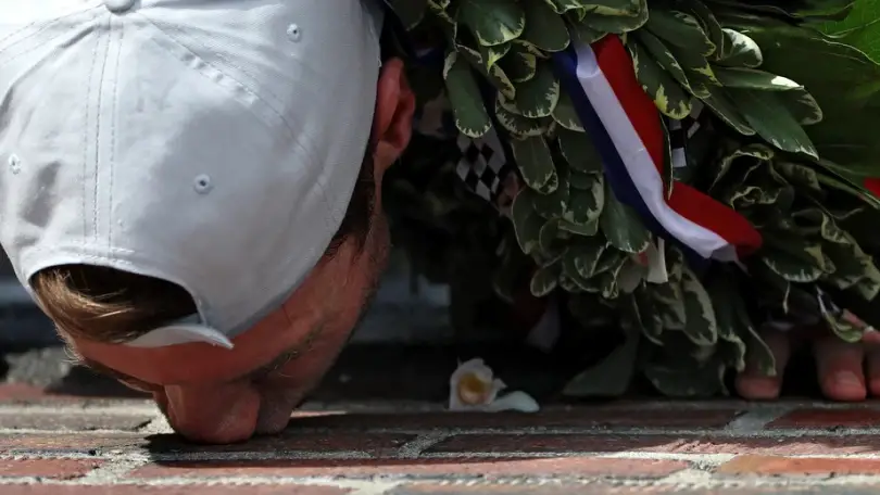 IndyCar driver Will Power kisses the bricks after winning the prestigious Indianapolis 500 at Indianapolis Motor Speedway