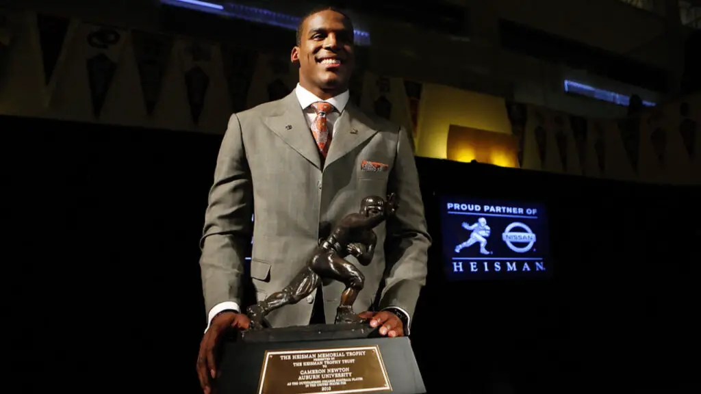 Auburn Tigers quarterback Cam Newton poses with the 2010 Heisman Memorial Trophy Award at the New York Marriott Marquis in New York City