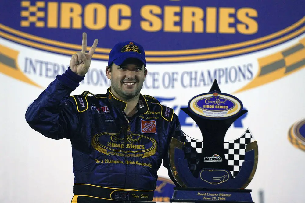 Racing legend Tony Stewart poses with the trophy after winning the Crown Royal IROC auto race
