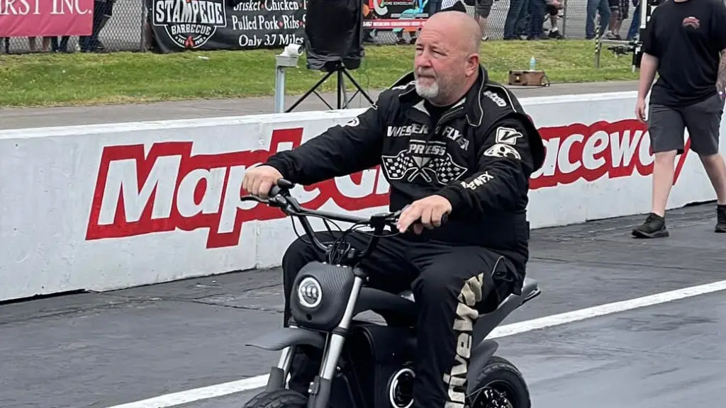 Street Outlaws No Prep Kings star Chuck Seitsinger riding on the drag strip during a break in the action during the filming