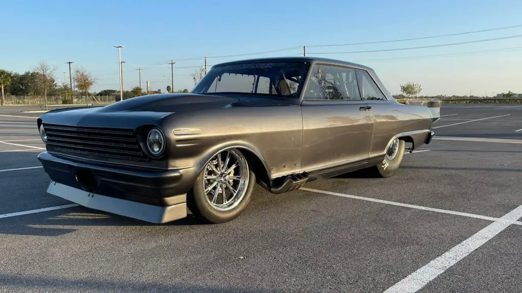Street Outlaws No Prep Kings star Daddy Dave Comstock's Goliath in the parking lot of a dragstrip