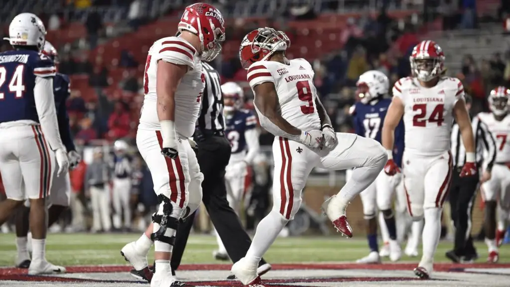Louisiana Lafayette running back Emani Bailey celebrates a touchdown in a college football game