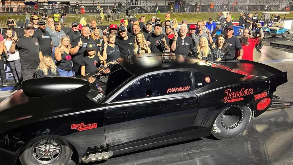 Street Outlaws star Kye Kelley celebrating his fourth Street Outlaws No Prep Kings win by his race car Show Stopper at Virginia Motorsports Park