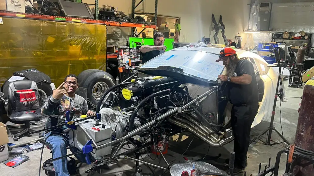 A man works on Prenup’s rebuild at Cameron Johnson Race Cars before the car was completely rebuilt from a fire and crash at Maple Grove Raceway