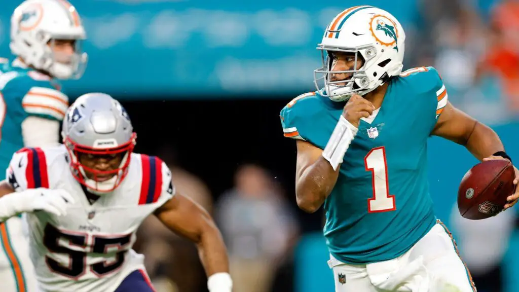 Miami Dolphins quarterback Tua Tagovailoa scrambles against the New England Patriots defense in the second quarter of their game 
